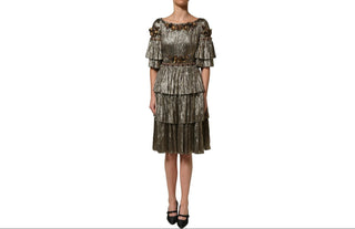 A metallic bronze and olive green tiered dress with off-the-shoulder ruffle sleeves and a decorative belt, shown on a model against a white background.