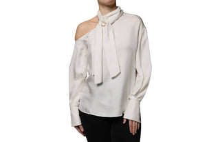 A white eyelet blouse with a large Peter Pan collar, button-front closure, and voluminous long sleeves with lace trim, shown on a model against a plain white background.