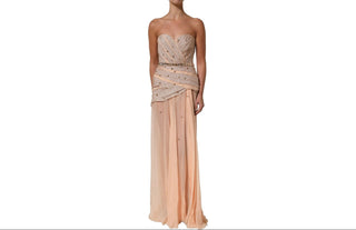A strapless formal gown with a beaded sweetheart bodice and draped waist, paired with a flowing chiffon skirt in a soft peach color, shown on a headless mannequin against a white background.
