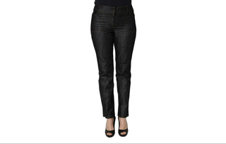 Black slim-fit jeans shown on a headless mannequin lower body with black high heels, against a plain white background.