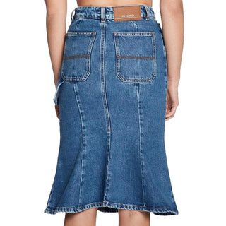 Blue denim skirt worn by a person on a white background