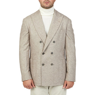 Man wearing a double-breasted blazer over a white turtleneck on a white background