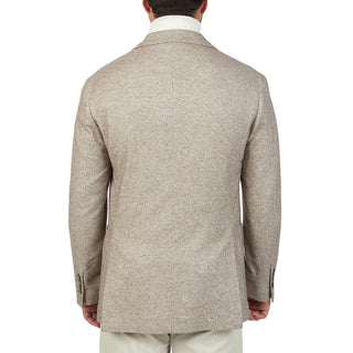 Man wearing a beige textured overcoat on a white background