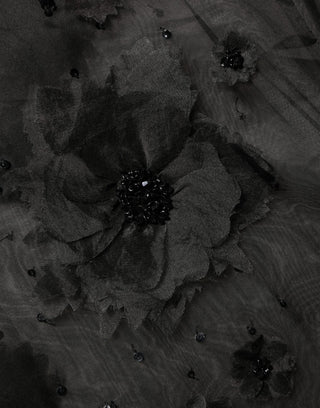 Camisa negra transparente de manga corta con aplique floral