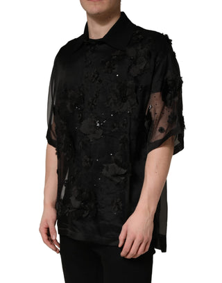 Camisa negra transparente de manga corta con aplique floral