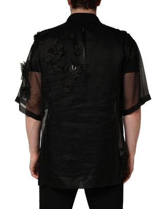 Camisa negra transparente de manga corta con aplique floral