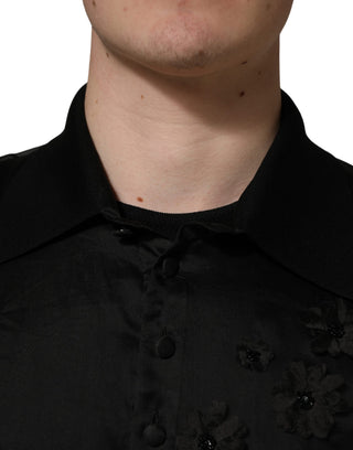 Camisa negra transparente de manga corta con aplique floral