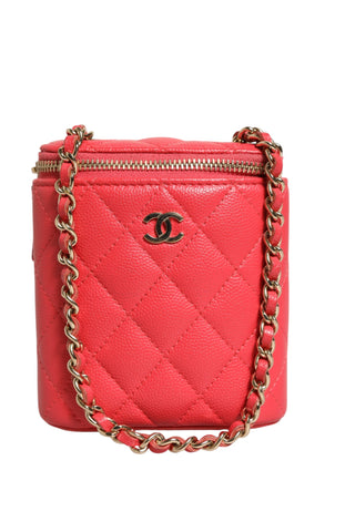 Pink quilted handbag with gold chain and Chanel logo on a white background