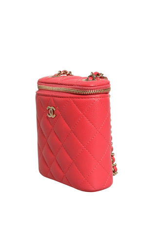 Red quilted handbag with gold accents on a white background