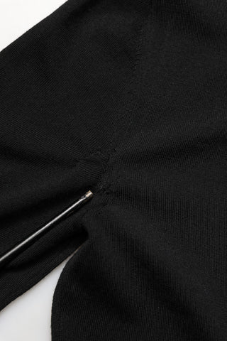 Close-up of a black fabric with a zipper on a white background