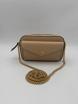 Beige handbag with a gold chain on a light gray background