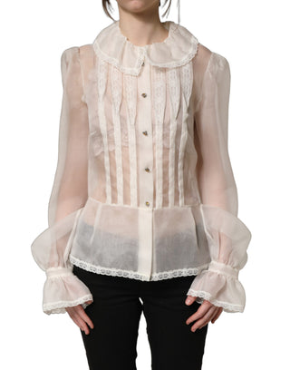 Blusa blanca de seda transparente con volantes y botones