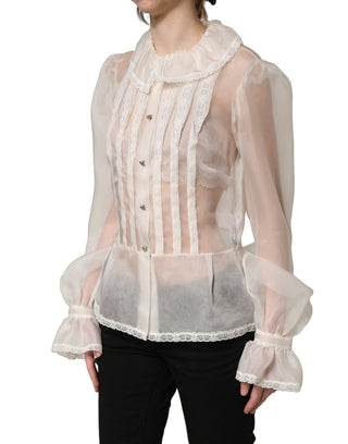 Blusa blanca de seda transparente con volantes y botones