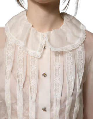 Blusa blanca de seda transparente con volantes y botones