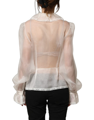 Blusa blanca de seda transparente con volantes y botones