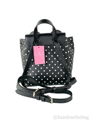 Black polka dot backpack with a pink tag on a white background