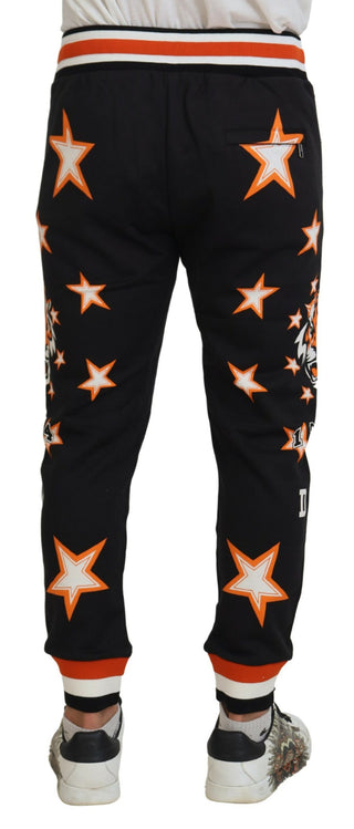 Pantalones deportivos con estrella naranja y negro