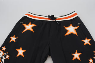 Pantalones deportivos con estrella naranja y negro