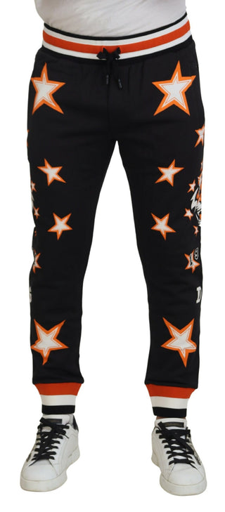Pantalones deportivos con estrella naranja y negro