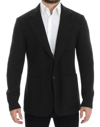 Black suit jacket worn by a person on a white background