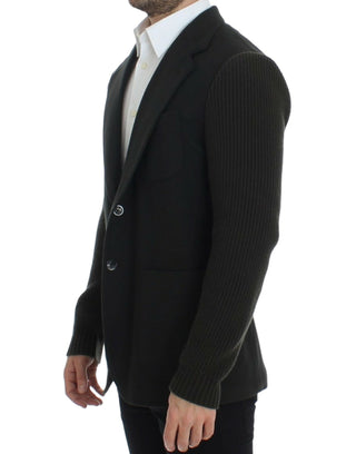 Black blazer worn by a person on a white background