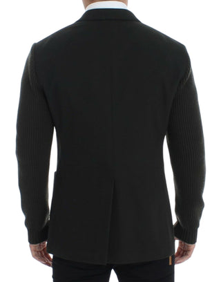 Black ribbed sweater worn by a person on a white background