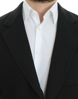 Close-up of a black blazer over a white shirt with a white background