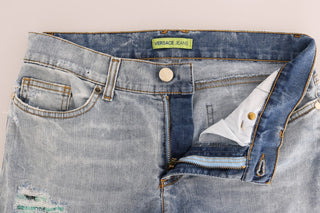 Jeans slim fit de algodón con lavado azul desgastado