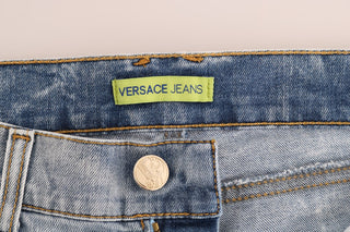 Jeans slim fit de algodón con lavado azul desgastado