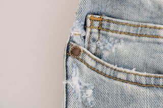 Jeans slim fit de algodón con lavado azul desgastado