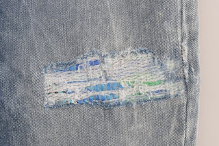 Jeans slim fit de algodón con lavado azul desgastado