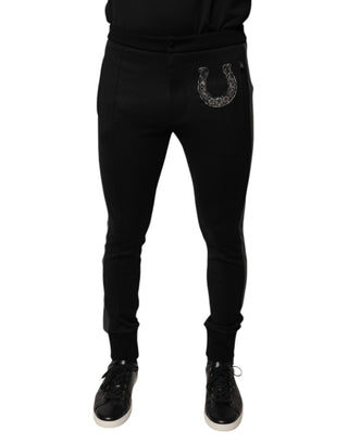 Pantalones ajustados de lana negra con adorno de herradura