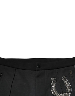 Pantalones ajustados de lana negra con adorno de herradura