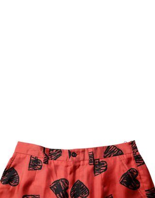Orangefarbene Seiden-Bermudashorts mit Herzaufdruck