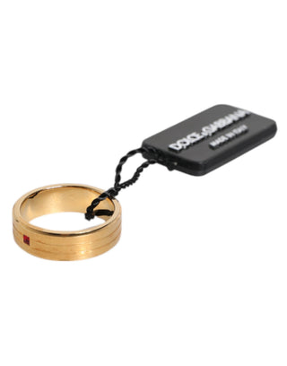 Goldfarbener Messingring mit roten Kristallen und DG Logo