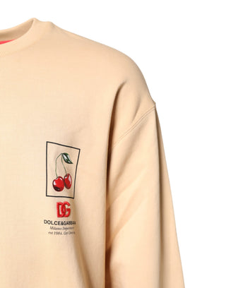 Beigefarbener Pullover mit Kirschdruck und Rundhalsausschnitt