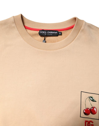 Beigefarbener Pullover mit Kirschdruck und Rundhalsausschnitt