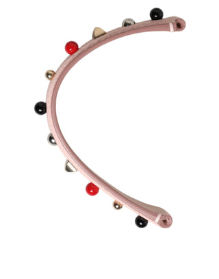 Bolso de cuero rosa claro adornado con asa y correa de hombro