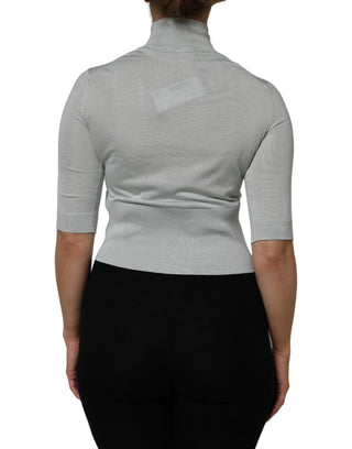 Top gris con cuello alto tipo tortuga y mangas 3/4
