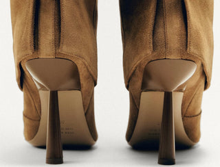 Brown high-heeled shoes on a white background